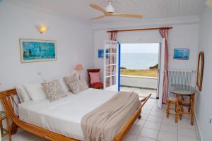 A bed or beds in a room at Aroura Homes 4BR Beachfront Villa