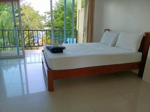 a bedroom with a bed with a laptop on it at Pranee Bungalow in Ko Tao