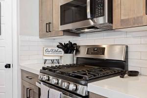 a kitchen with a stainless steel stove and microwave at Escondido Cove in Washington
