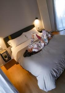 two people laying on a bed in a room at Residenza Gramsci in Matera