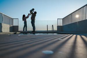 two men are standing on a skateboard ramp at Anici Crt Penthouse 4 - with private rooftop pool in Victoria