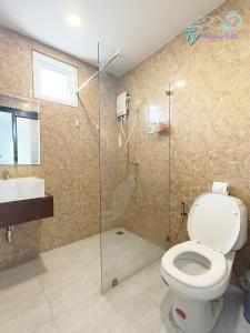 a bathroom with a toilet and a shower and a sink at TY Holiday Resort in Pattaya Central