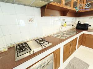 a kitchen with a stove and a sink at TY Holiday Resort in Pattaya Central