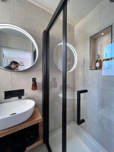 a bathroom with a shower and a sink and a mirror at Norton house in Brighton & Hove