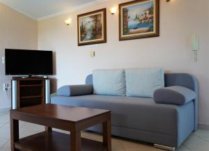 a living room with a blue couch and a table at Villa Ilias in Parga