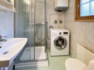 a bathroom with a washing machine and a sink at 6 person holiday home in YNGSJÖ-By Traum in Yngsjö +12 photos