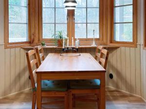 a dining room table with two chairs and two windows at 6 person holiday home in YNGSJÖ-By Traum in Yngsjö