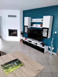 a living room with a table and a fireplace at La pause ô logis gourmande in Navarrenx