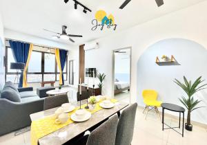 a dining room and living room with a table and chairs at Bali Residence I B3105 Luxury 2BR I Seaview I 6-9pax l WaterPark I CityCentre by Jay Stay in Melaka