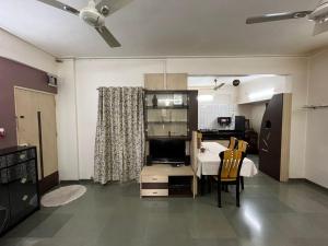 a kitchen with a table and a dining room at Tripvana Apartment in Nashik