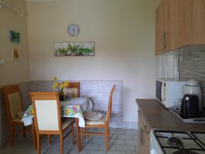 a kitchen with a table and two chairs and a table at Alexander apartman in Gyula