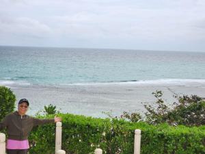 a woman standing in front of the ocean at JOH & BONG CONDO UNIT RENTAL-BORACAY OCEANWAY RESIDENCES in Boracay