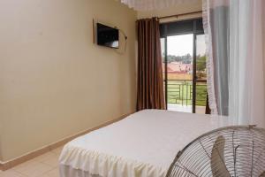 Postel nebo postele na pokoji v ubytování Tristar Hotel Kampala