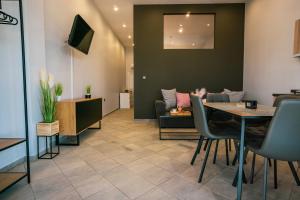 a living room with a table and a couch at Seashell Luxury Apartment in Nikiti