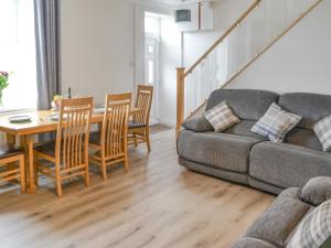 a living room with a couch and a table at Gloster House in Amble