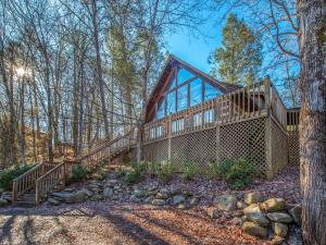 a house in the woods with a wrap around deck at Bear Cave Haus, 2 Bedrooms, Fireplace, Hot Tub, Pool Table, WiFi, Sleeps 8 in Gatlinburg