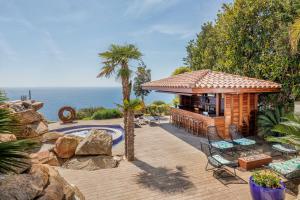 a backyard with a gazebo next to the ocean at Casa Nami Costa Brava - BY EMERALD STAY in Sant Feliu de Guíxols