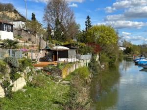 a river with a house next to a river at Casa Ländli in Grenzach-Wyhlen