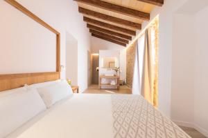 a bedroom with a white bed and a window at Petit Palau Alcudia - Adults Only in Alcudia