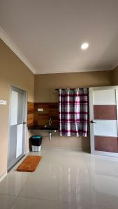 a living room with a sink and a window at Cenang Room Rahsia Motel in Pantai Cenang