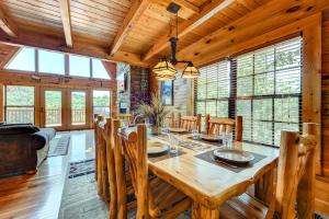 a dining room with a wooden table and chairs at A Majestic View III in Townsend