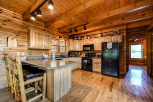 a kitchen with wooden floors and a black refrigerator at A Majestic View III in Townsend