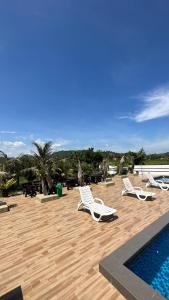 a patio with lounge chairs and a swimming pool at Cenang Room Rahsia Motel in Pantai Cenang