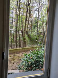 a window with a view of a fence at AUTEUIL PASSY in Paris