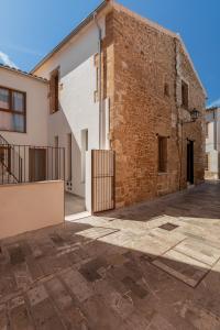 a brick building with a gate in front of it at Petit Palau Alcudia - Adults Only in Alcudia