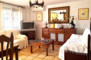 een woonkamer met een bank en een tv bij Casa Aguacate in Taramay