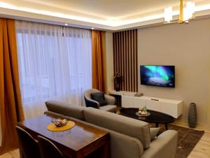 a living room with a couch and a tv at Elegant and comfy apartment in Westlands, Nairobi in Nairobi