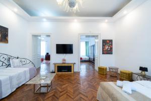 a living room with a couch and a tv at 5* noble house in historic center in Cluj-Napoca