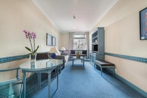 a living room with a couch and a table at Espahotel Gran Vía in Madrid