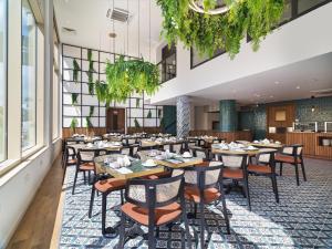 an image of a restaurant with tables and chairs at Leonardo Boutique Hotel Larnaca in Larnaca