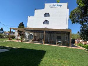 a white building with a large window on the side of it at Casa Del Mar Hotel & Apartaments in Roses