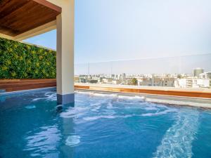 a swimming pool on the roof of a building at Leonardo Boutique Hotel Larnaca in Larnaca