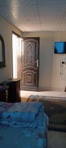 a bedroom with a bed and a wooden door at Sphinx Dream Nights Cairo in Cairo