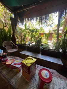 a table with some food on it with a window at Big Daddy´s Surfcamp in Pasanggaran