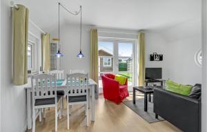 a kitchen and living room with a table and chairs at Two-Bedroom Holiday Home In Otterup in Otterup