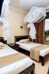 Postel nebo postele na pokoji v ubytování Tristar Hotel Kampala + 37 fotografií