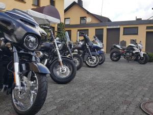 a row of motorcycles parked in a parking lot at Alte Dorfschänke in Kinderbeuern