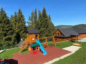 a playground with a slide and a slideintend at Penzion Relax in Nižná