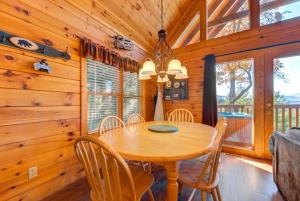a dining room with a wooden table and chairs at Cub’s Corner, 3 Bedrooms, Pool Access, Hot Tub, Pool Table, Sleeps 10 in Gatlinburg