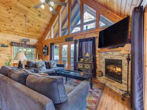 a living room with couches and a fireplace at Cub’s Corner, 3 Bedrooms, Pool Access, Hot Tub, Pool Table, Sleeps 10 in Gatlinburg