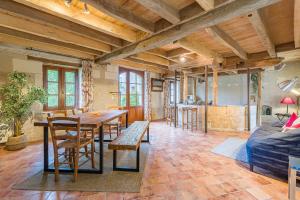 a living room with a table and chairs and a couch at Moulin du Fief Gentil in Bléré