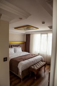 a hotel room with a large bed and a window at Blue Zerzevan Konak Hotel in Istanbul