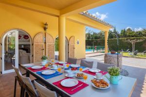 a table with food on it on a patio at Villa Ocaso by JS Villas in Port de Pollensa