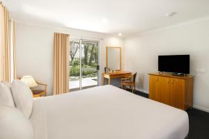 um quarto de hotel com uma cama e uma televisão em Bayview Geographe Resort Busselton em Busselton