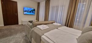 a bedroom with a bed with two white towels on it at Carice Milice Old Town Residence in Belgrade