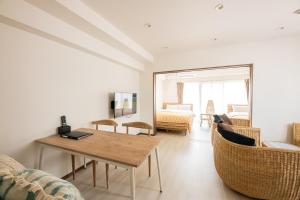 a living room with a table and chairs at Tomariehoteru & kondominiamu - Vacation STAY 46773v in Fukuoka